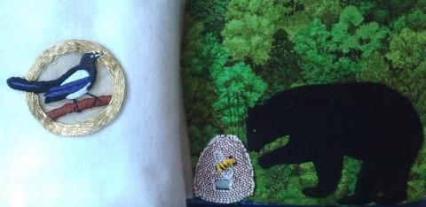 Magpie in a gold circle on the left, fleece bear approaching a beehive on the right