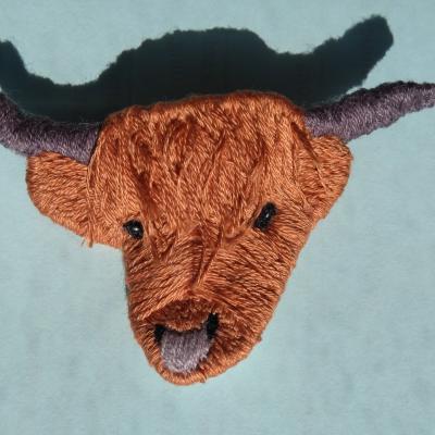 Embroidered head of a Highland cow